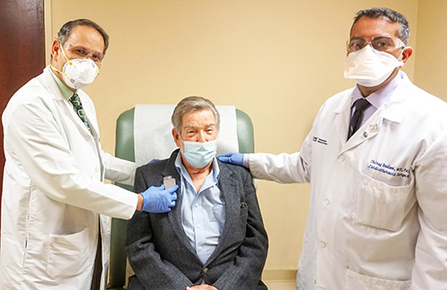 Gunjan Shukla, MD, Clinical Director of Cardiac Electrophysiology, and Cardiothoracic Surgeon Chirag Badami, MD demonstrate how the device works with Joseph Carozza, 76, of Hopewell Junction, NY, the first patient to undergo this minimally-invasive procedure at Good Samaritan Hospital.